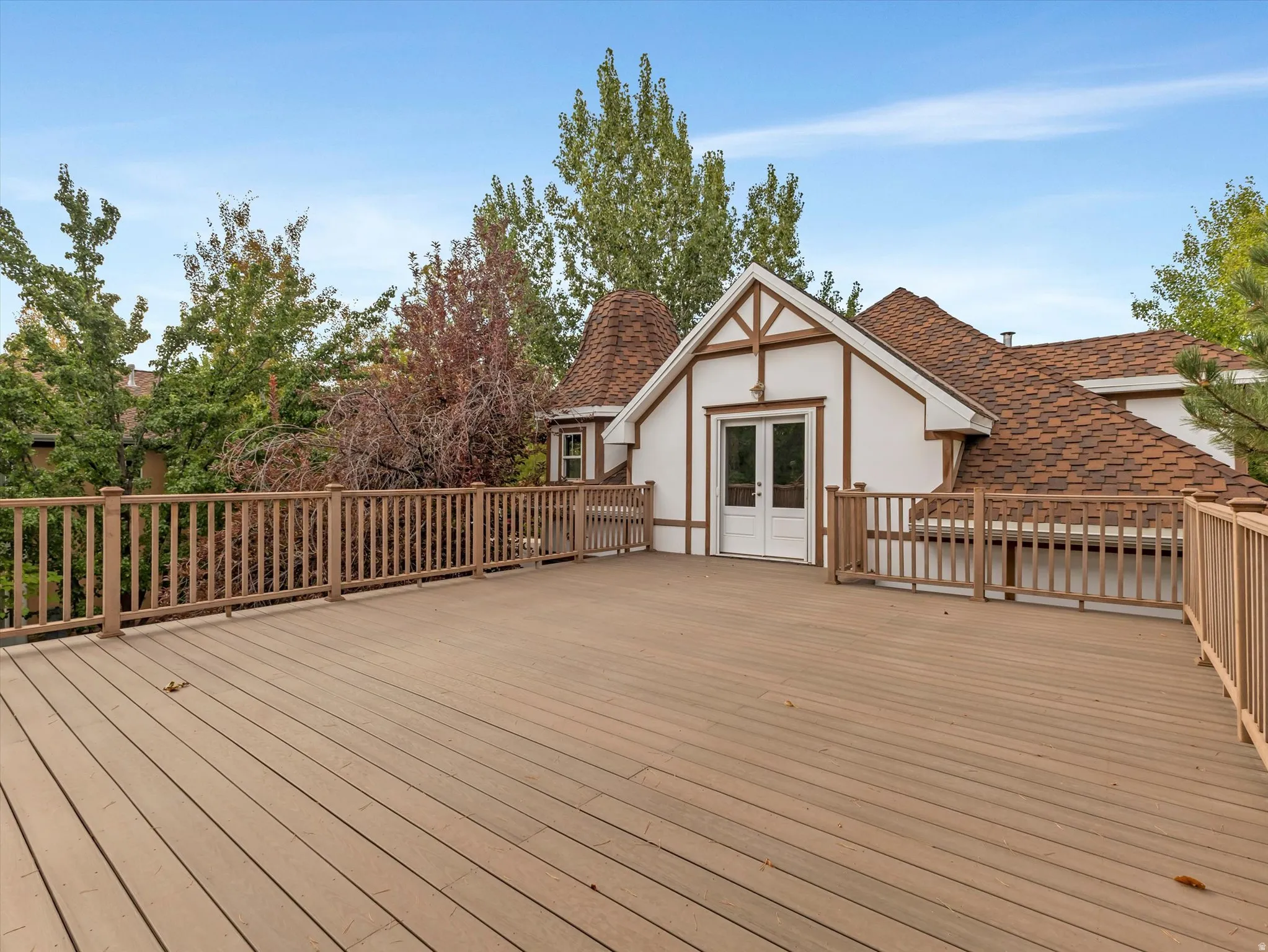 Expansive brand new deck featuring wood-look composite decking and a wood railing system