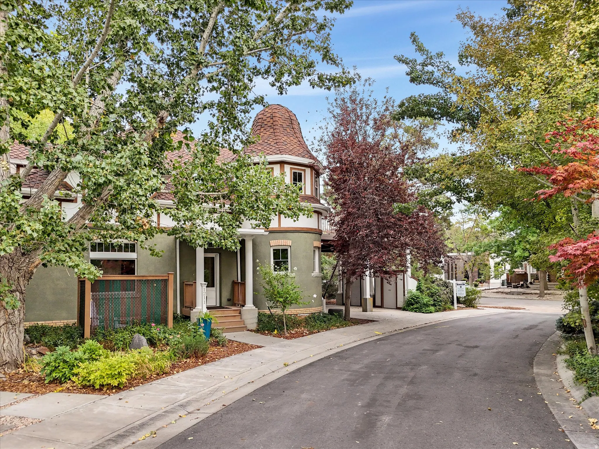 Exterior featuring a distinctive conical roof, stucco facade, and decorative trim and front patio