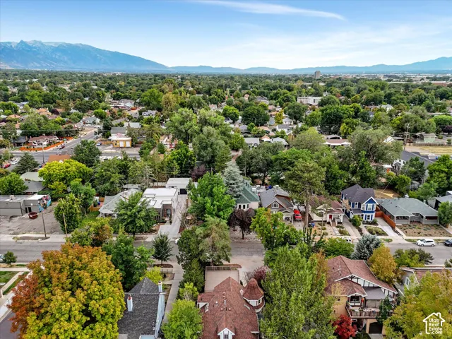 Mountain and valley views, expansive residential area featuring a diverse collection of homes, mature trees, and a distant mountain range
