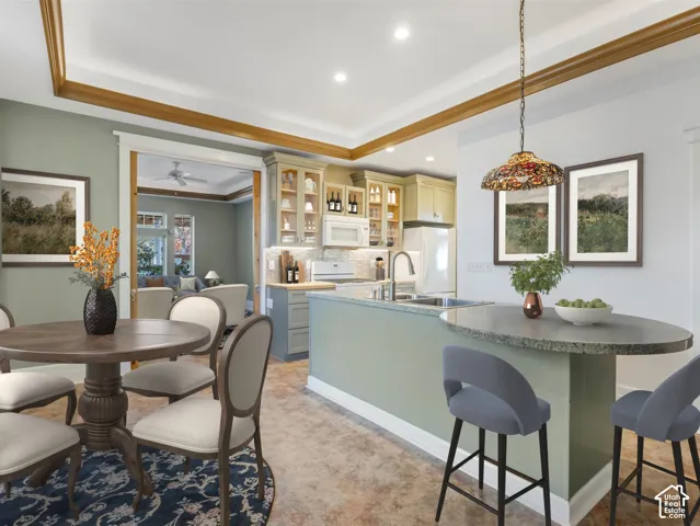 Kitchen with custom cabinetry, recessed lighting, and a kitchen island with an extended counter