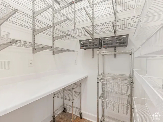 White countertop with ample surface area, multiple power outlets, and extensive wire shelving