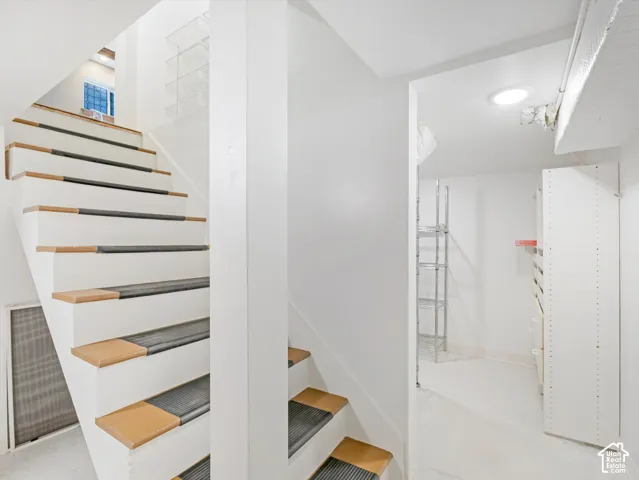 White painted staircase with wood-finish treads and risers