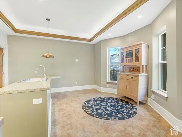 Kitchen area with a granite-style countertop, undermount sink, and gooseneck faucet