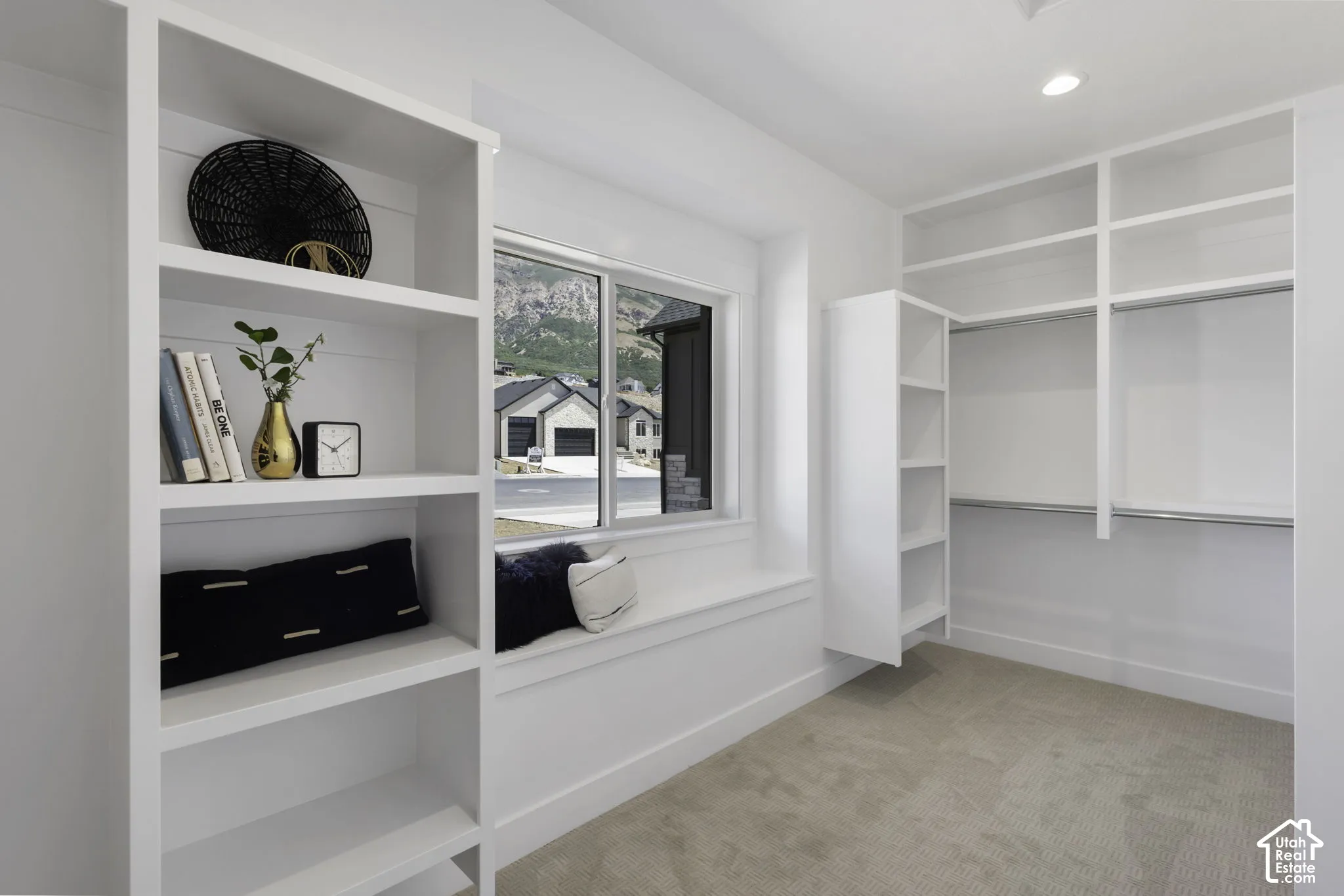 Built-in shelving, integrated window seat, recessed lighting, and wall-mounted closet organization system