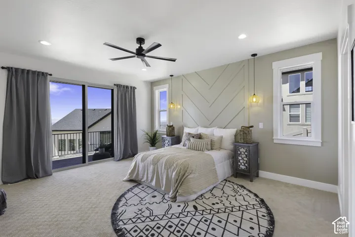 Carpeted room featuring a ceiling fan, recessed lighting, and a decorative accent wall