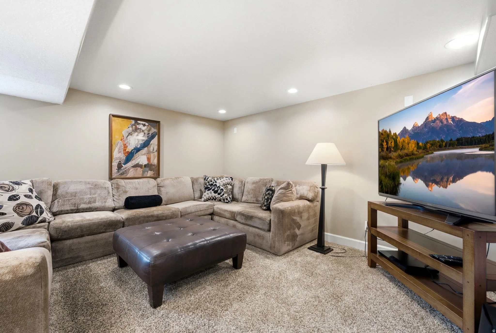 Recessed ceiling lighting, light neutral wall paint, and carpet flooring