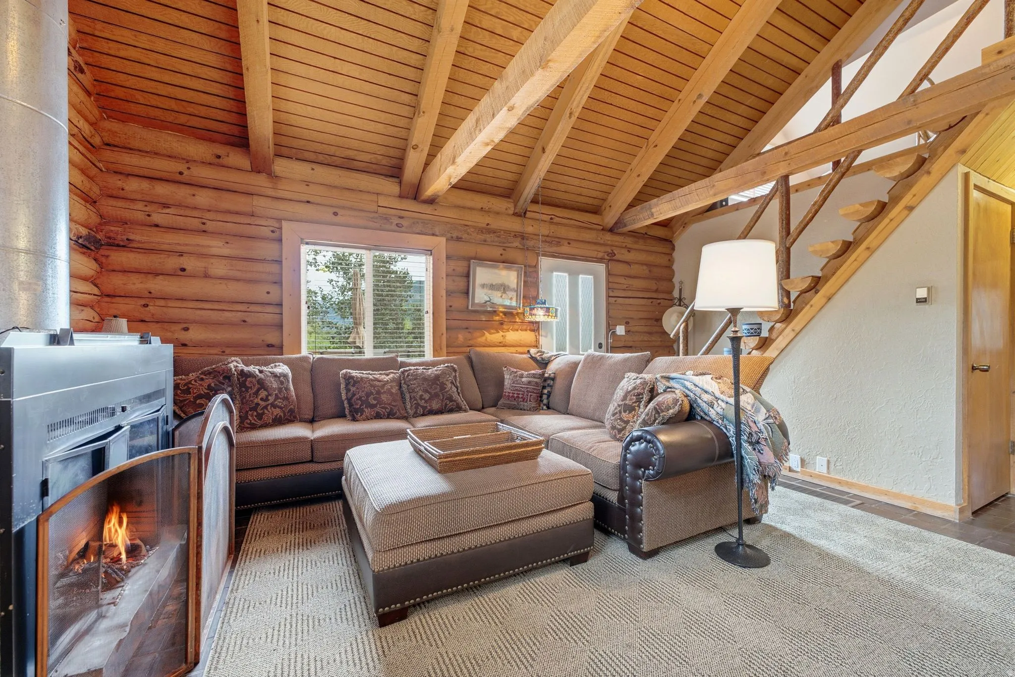Solid log walls with exposed wood ceiling beams