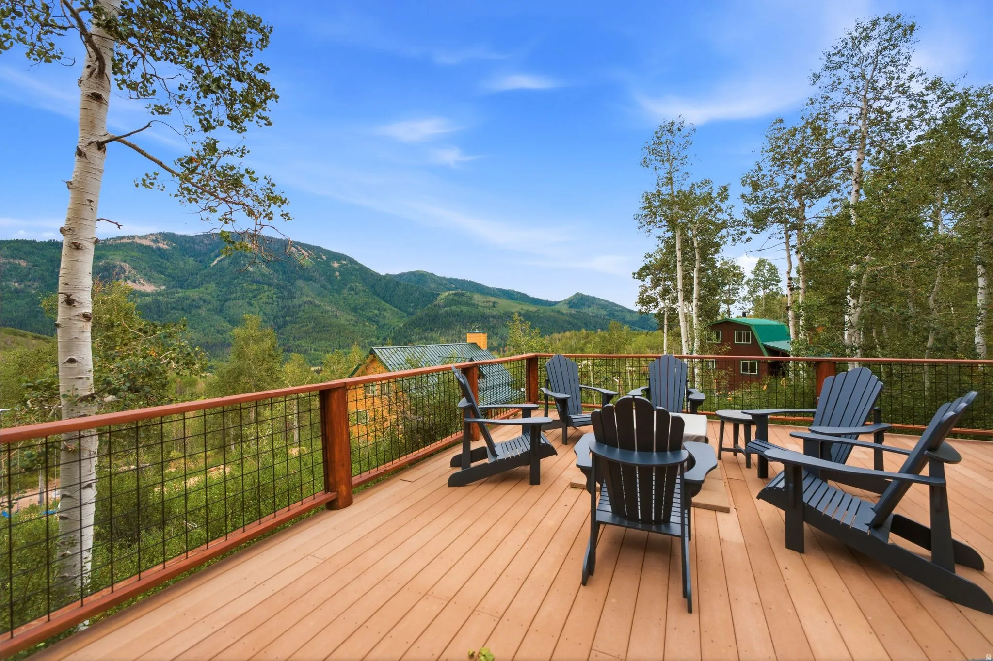 Expansive outdoor deck with wood-finish flooring and wire-mesh railing