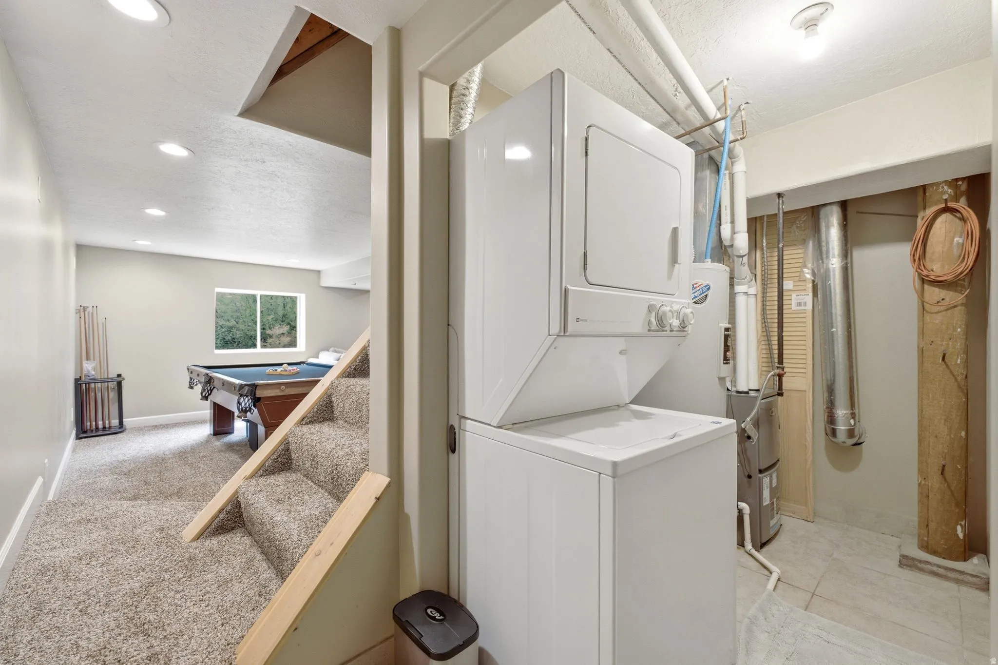 Finished lower level with recessed lighting, carpeted flooring, and a window