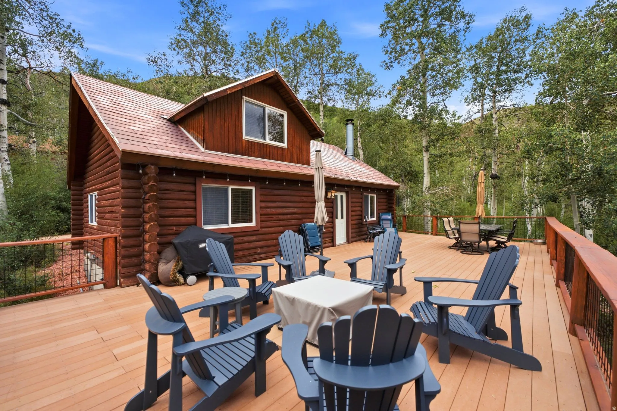 Wood-sided residence with log cabin construction and multiple windows