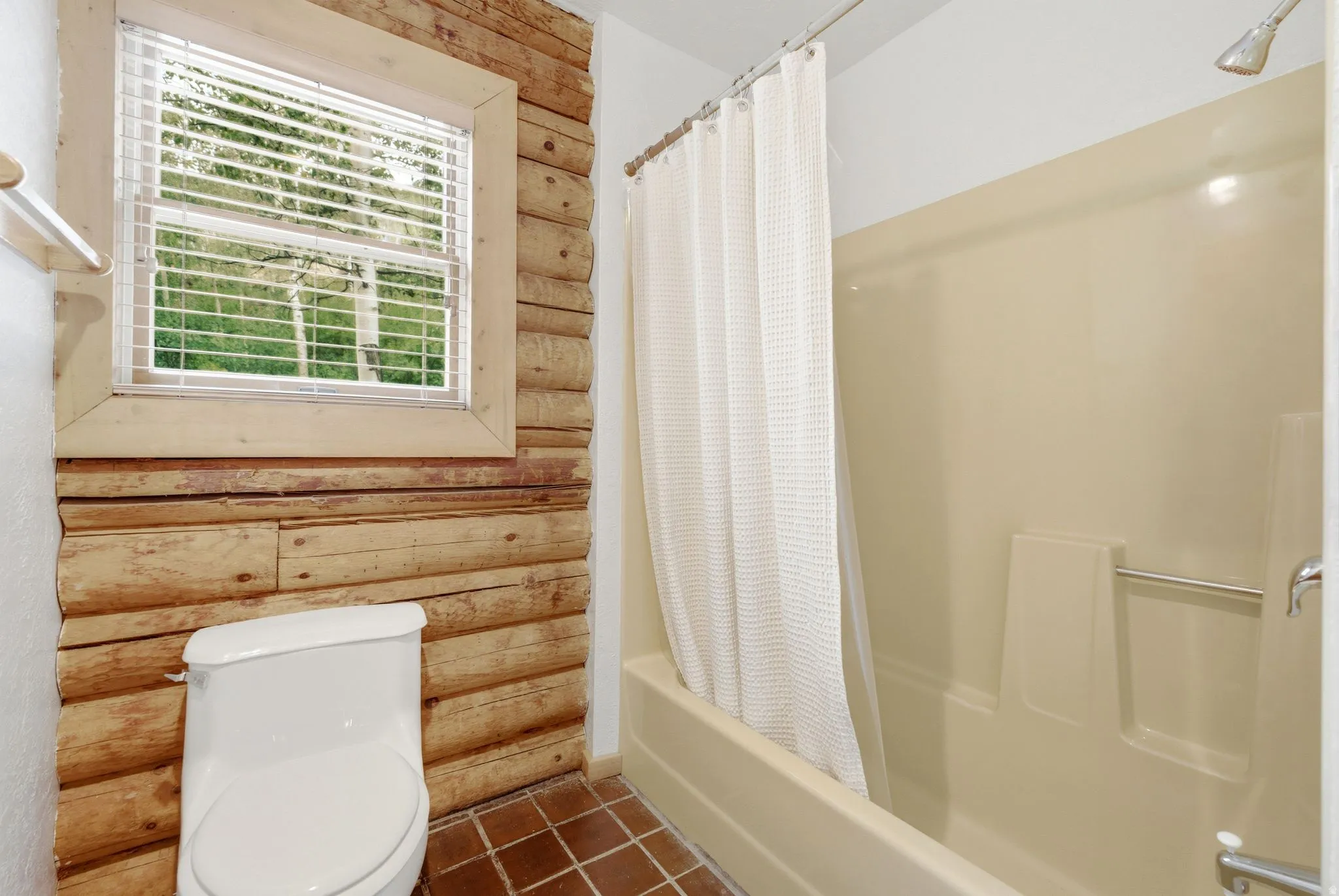 Wood-paneled wall accenting a window with blinds
