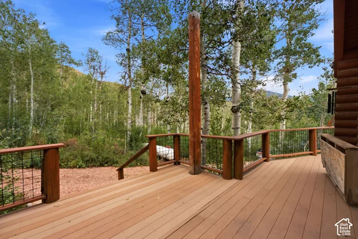 Expansive outdoor deck with wood-finish flooring and sturdy wood railings