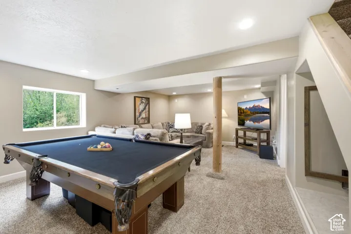 Recreational room featuring a pool table, carpeted flooring, and a window