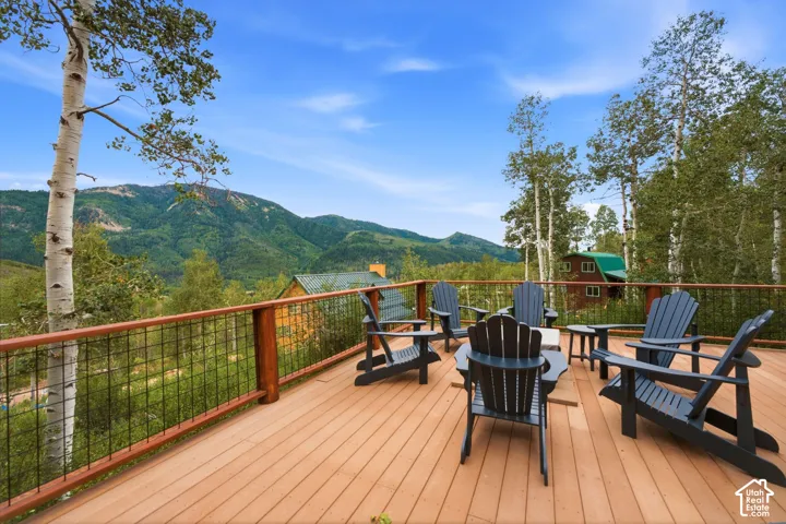 Expansive outdoor deck with wood-finish flooring and wire-mesh railing
