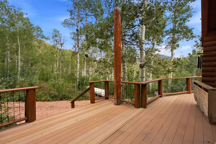 Expansive outdoor deck with wood-finish flooring and sturdy wood railings