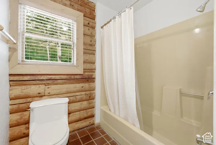 Wood-paneled wall accenting a window with blinds
