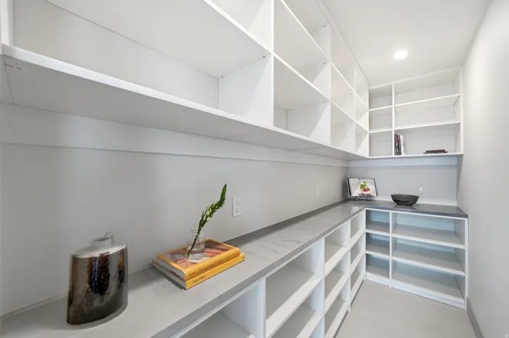 Extensive built-in shelving, ample countertop space, recessed lighting, and durable flooring