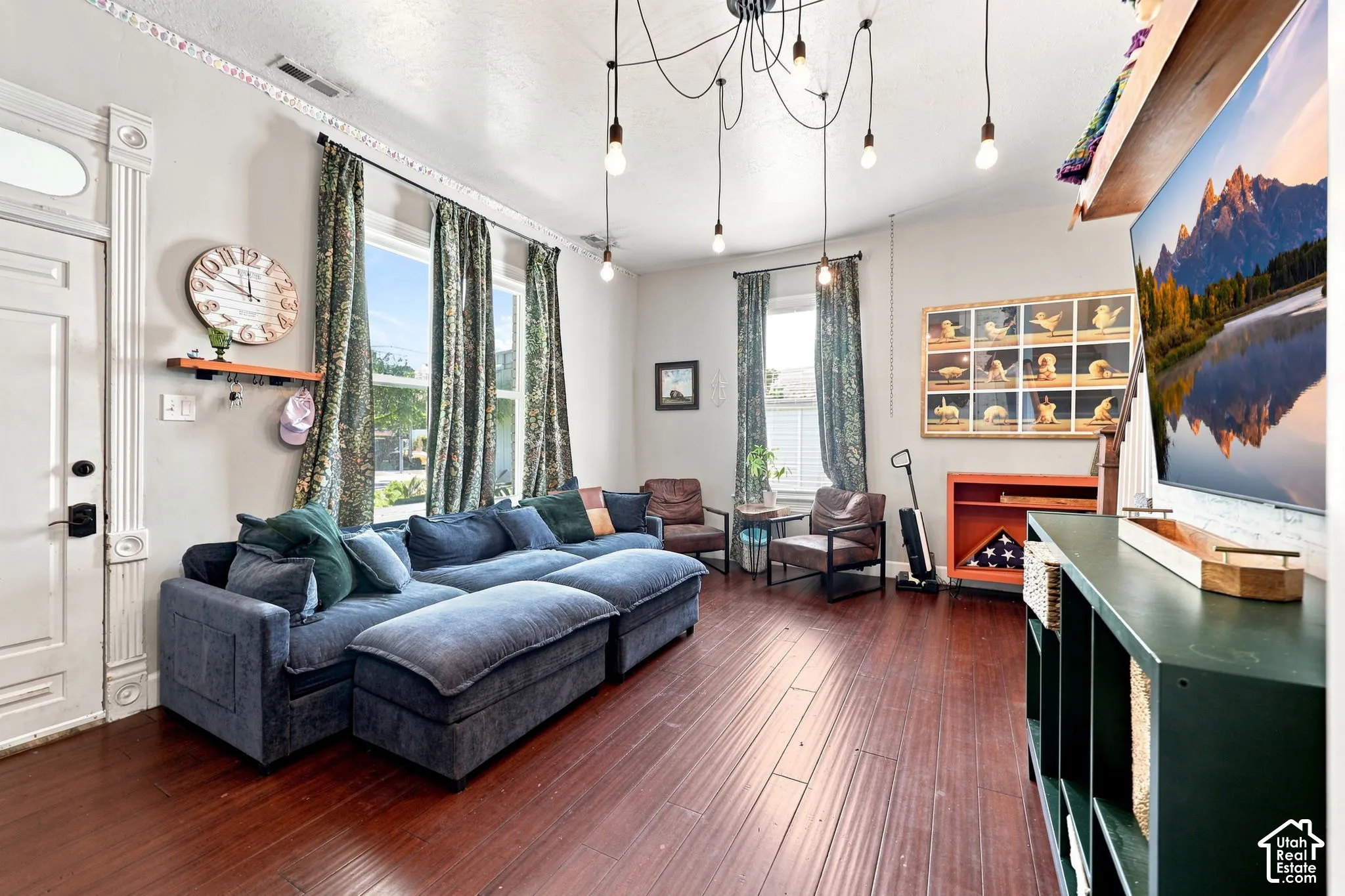 Dark wood-finish flooring complements the tall windows