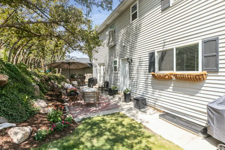 Siding exterior with decorative window shutters and a window planter box