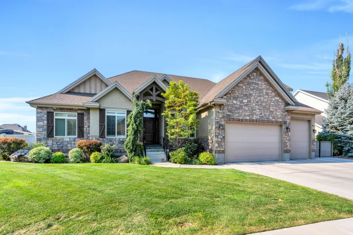 Front of home showing 3 car garage.