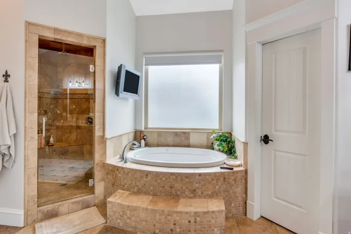 Primary suite with separate tub and shower.  Shower with 3 heads including rain shower.