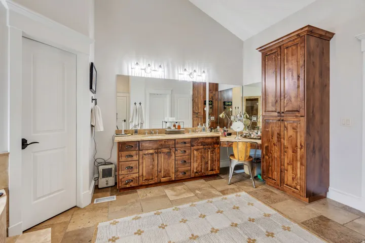 Primary bathroom suite vanity area and extra storage cabinets.