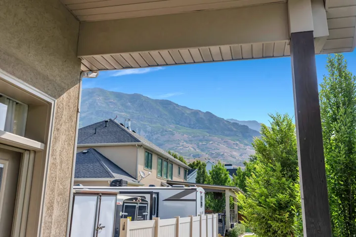 Covered porch with wood-finish support column and a mountain backdrop.
