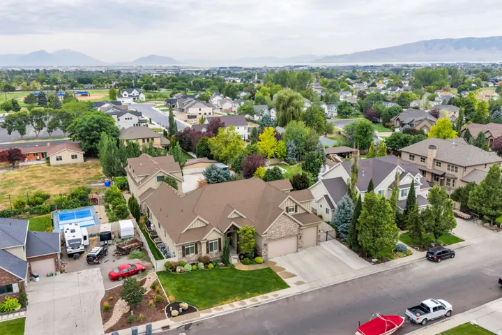 Expansive suburban neighborhood with mature trees and a distant mountain range.