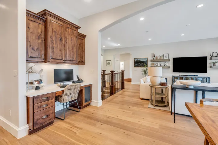 Integrated built-in desk with wood cabinetry and a light-toned countertop.