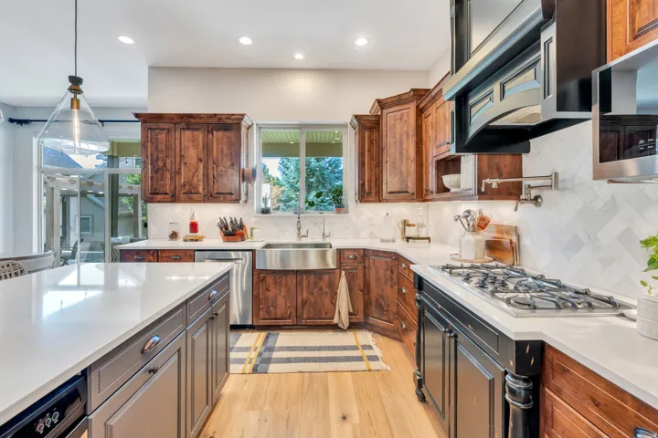 Gas cook top, two tone cabinets.