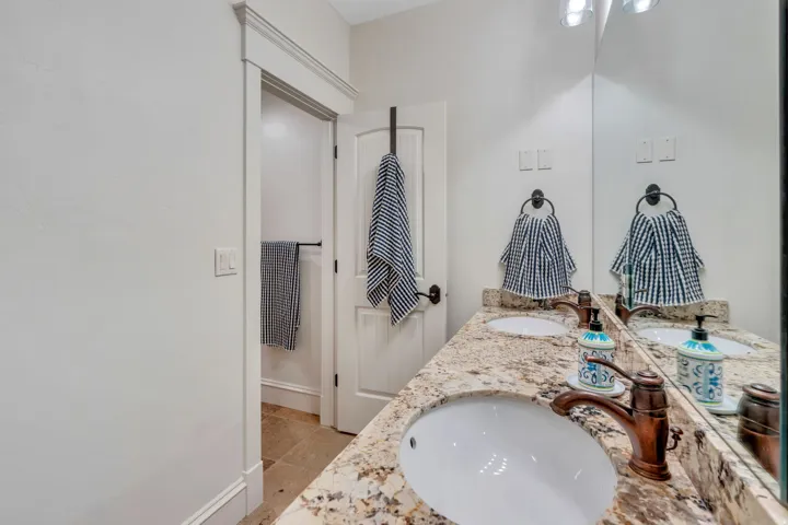 Spa-inspired bathroom featuring a curved vessel sink, granite countertop, and polished chrome fixtures.
