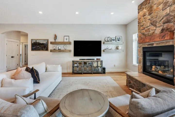 Stone-clad fireplace with a natural wood mantel.