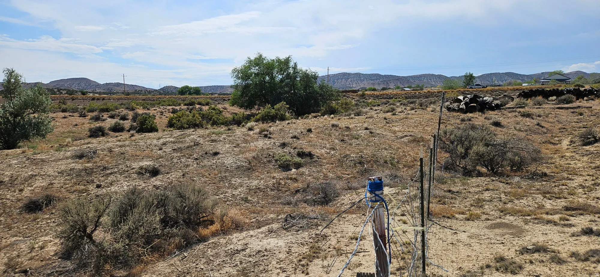 Expansive land parcel featuring natural desert vegetation and a distant mountain backdrop