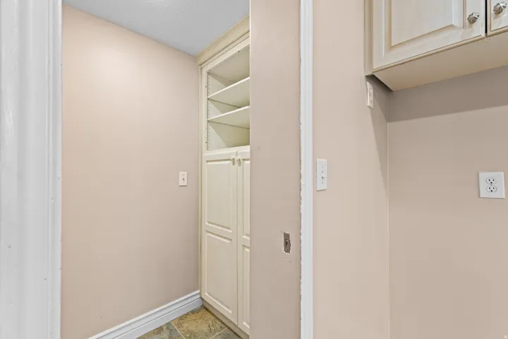 Built-in cabinetry with open shelving, closed storage, and decorative hardware