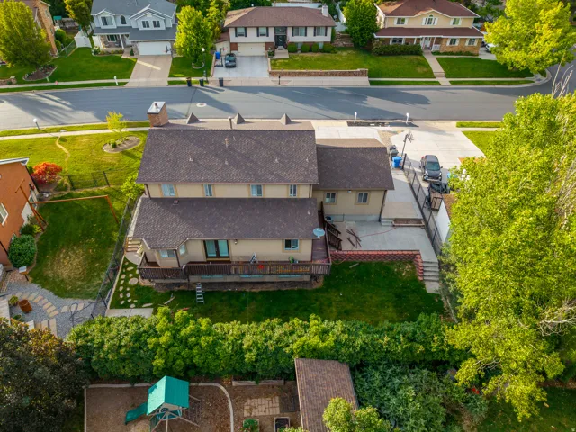 Multi-level property with a brown shingle roof and a rear elevated deck
