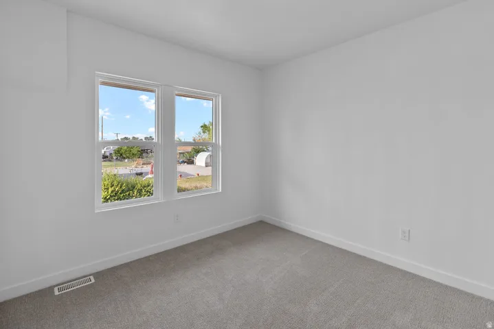 Neutral-toned carpeting with white walls and trim
