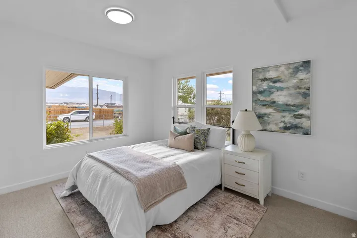 Bright interior with multiple windows, recessed lighting, and soft carpeting