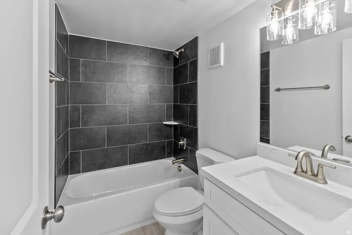 Tub and shower combination with dark tile surround