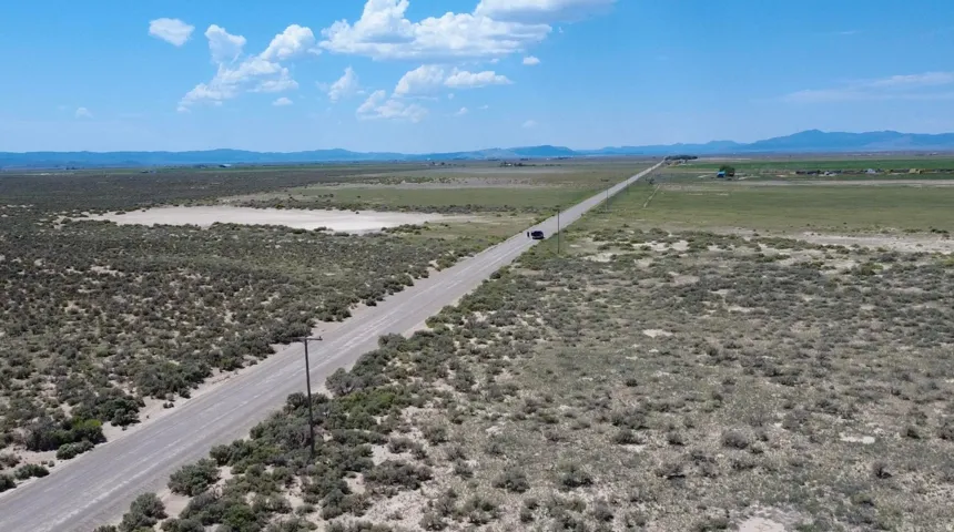 Expansive open terrain with a long, unpaved road
