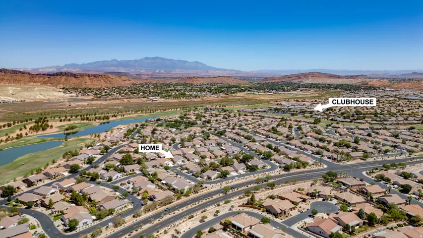 Aerial perspective showcasing residential development, surrounding natural landscape, and distant mountains