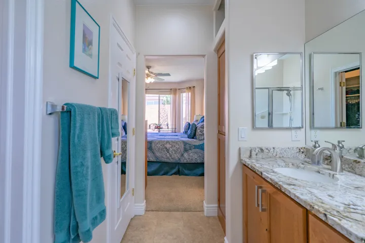 Bathroom vanity with a light-colored countertop and double mirrors