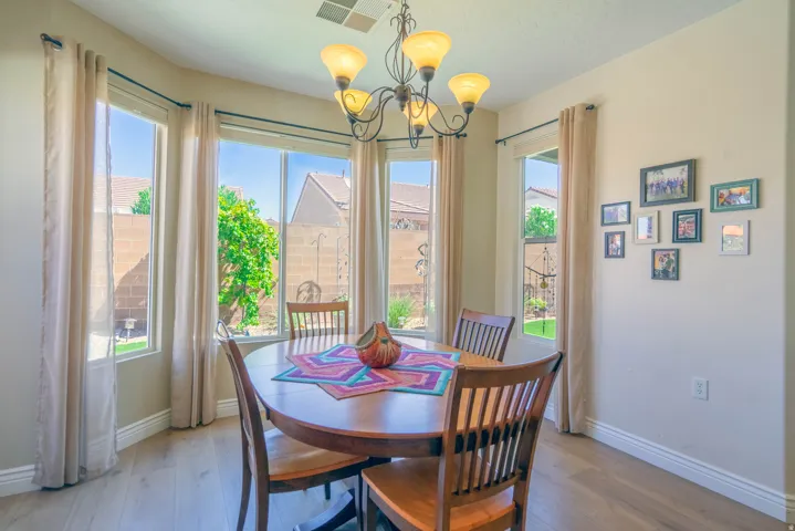 Wood-finish flooring, multiple large windows, and a built-in ceiling light fixture
