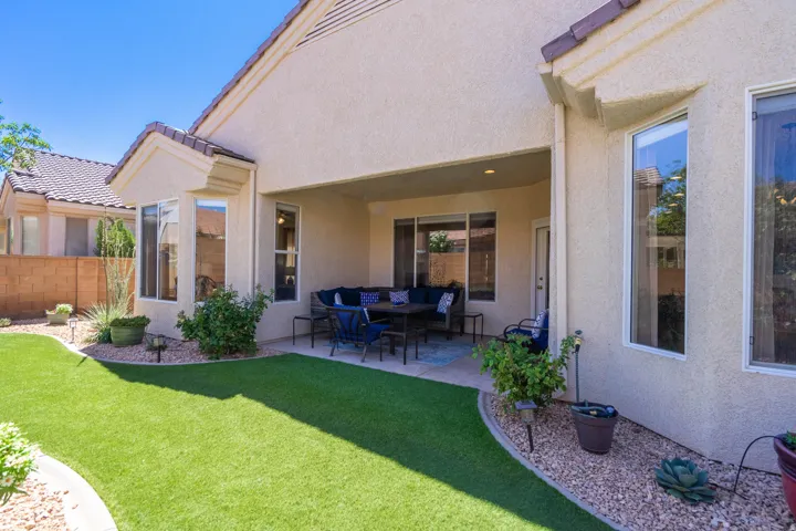 Covered patio with integrated lighting, stucco exterior, and multi-pane windows