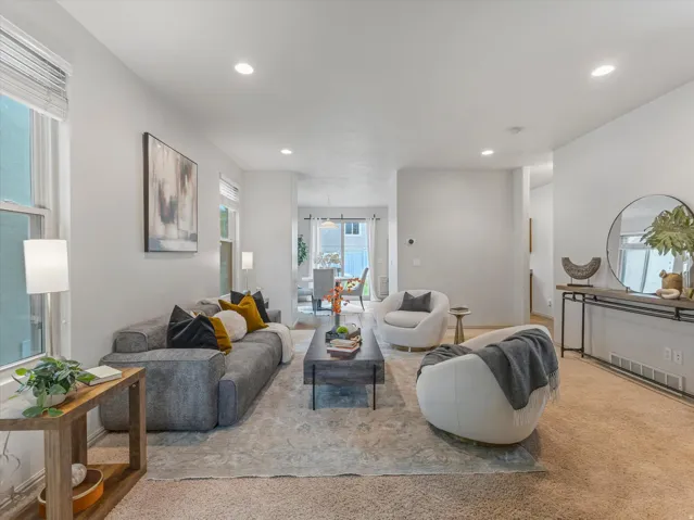 Recessed lighting, light-toned walls, and multiple windows provide bright illumination