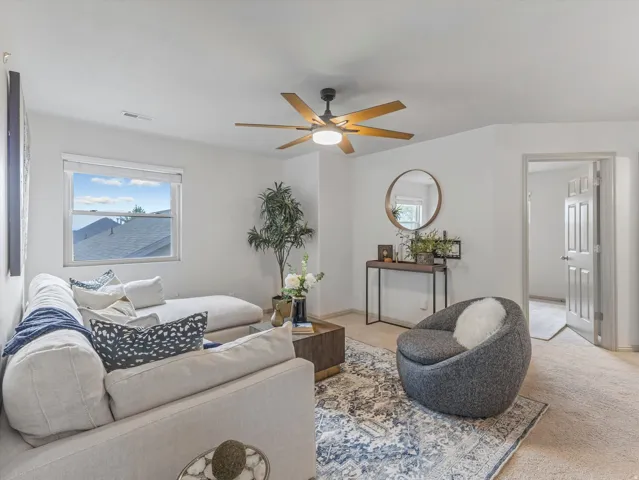 Neutral wall finishes and a ceiling fan with integrated lighting