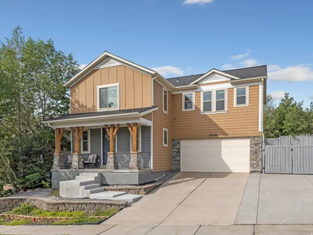 Two-story residence with a covered front porch featuring wood-clad columns