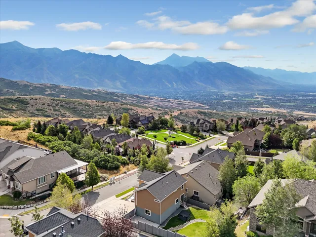 Expansive mountain range backdrop and a developed neighborhood with mature trees