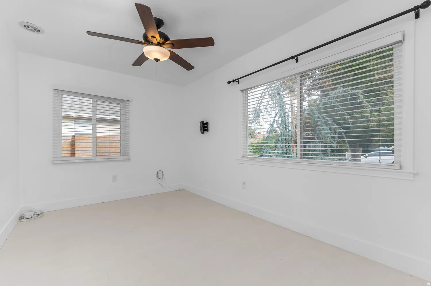 Recessed lighting with a ceiling fan, white walls, and light-colored carpet flooring