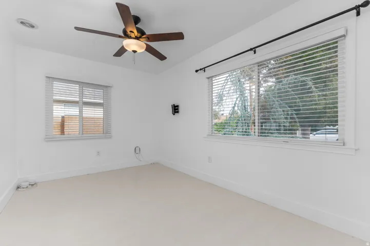Recessed lighting with a ceiling fan, white walls, and light-colored carpet flooring