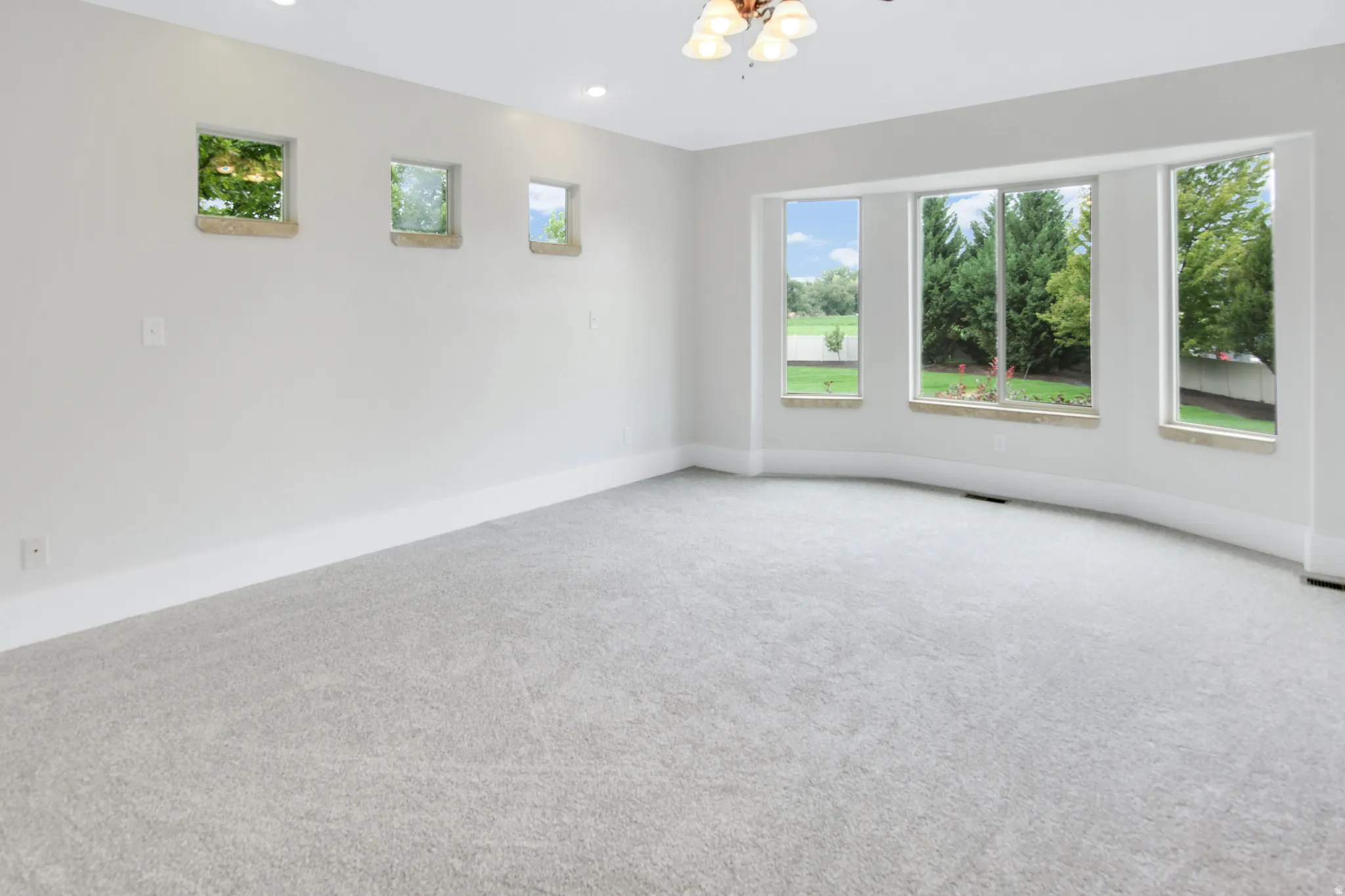 Master Bedroom with large windows overlooking large backyard and swimming pool.